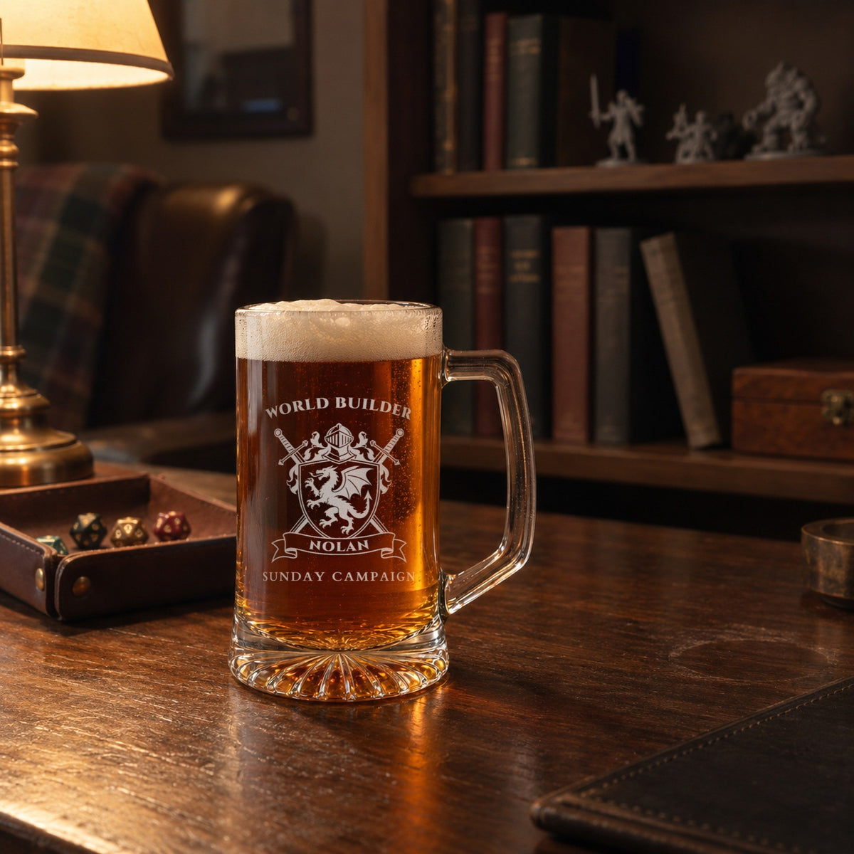 Engraved gamer beer mug on a walnut desk in a game room with miniatures and a dice tray, reading WORLD BUILDER, NOLAN and SUNDAY CAMPAIGN