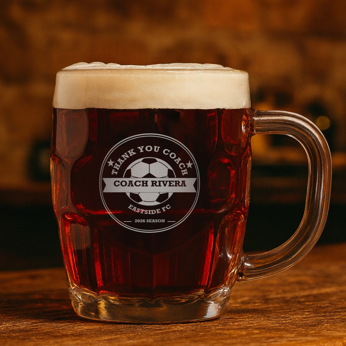 Engraved soccer coach beer stein with dark amber ale showing a second example: Thank You Coach, Coach Rivera, Eastside FC and 2026 Season