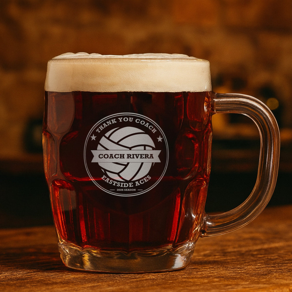 Engraved volleyball coach stein with dark amber ale reading Thank You Coach, Coach Rivera and Eastside Aces, showing the top line can be changed