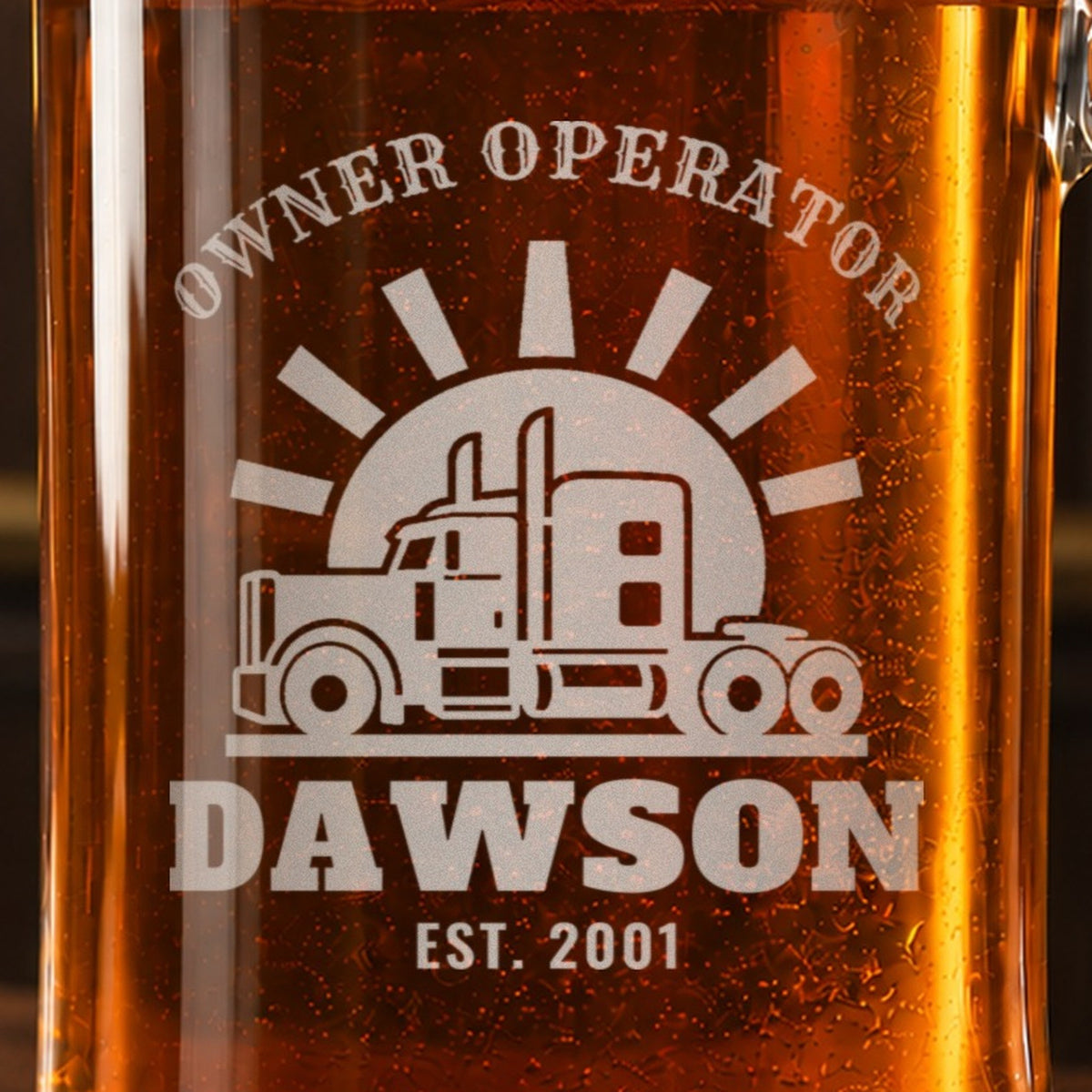 Close-up of the frosted semi truck and sunset engraving on an owner operator beer stein reading OWNER OPERATOR, DAWSON and EST. 2001