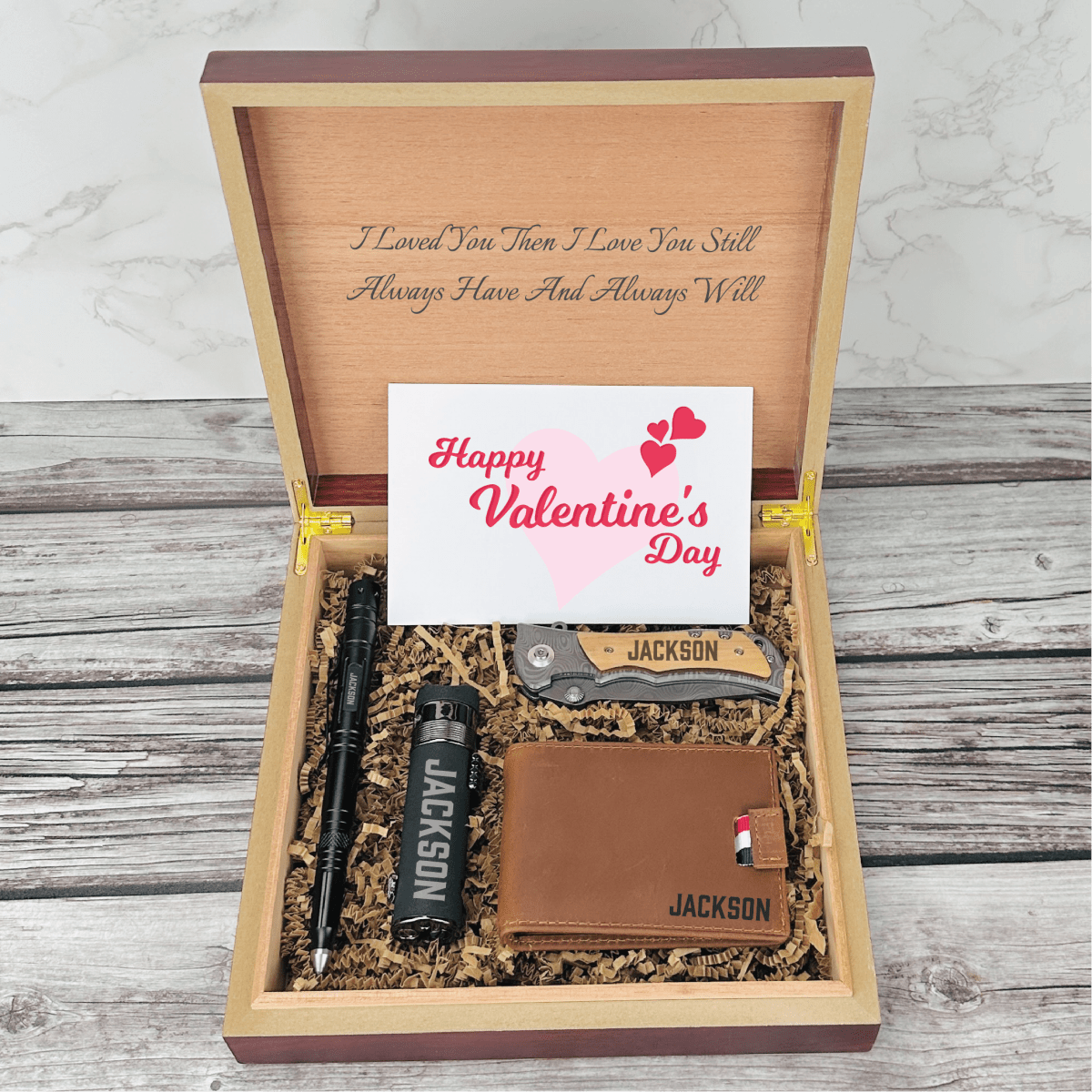 Personalized Valentine’s Day gift set for men featuring a tactical pen, triple torch lighter, wallet, titanium-coated knife, and engraved wooden box with custom name and message
