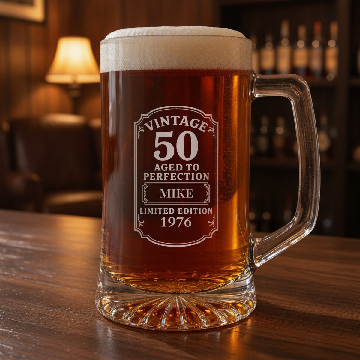 Vintage 50th birthday beer stein on a walnut home bar, frosted Vintage 50 Aged to Perfection label engraved with the name Mike and 1976