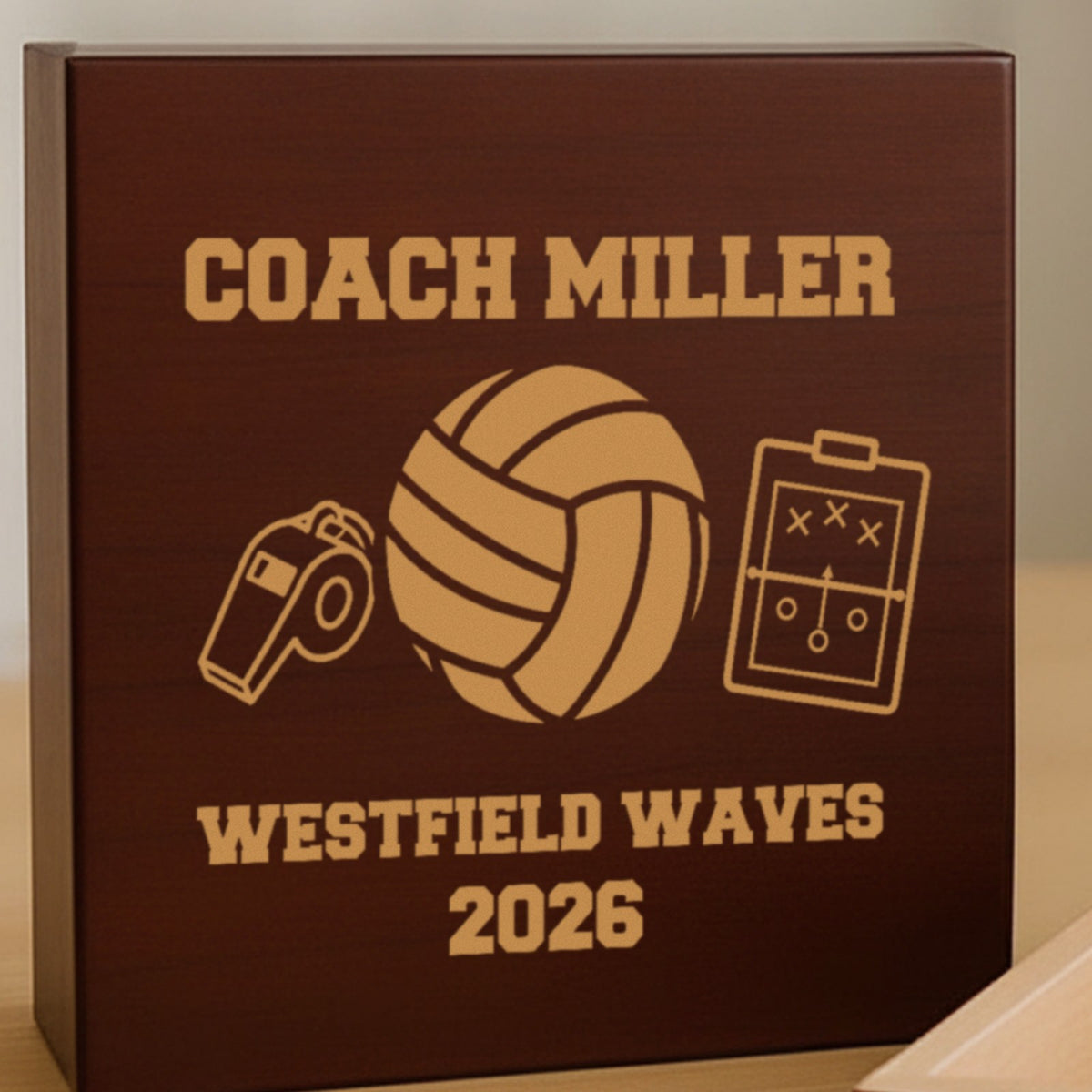 Engraved lid of a cherry volleyball coach keepsake box reading Coach Miller, a volleyball with a whistle and clipboard, and Westfield Waves 2026