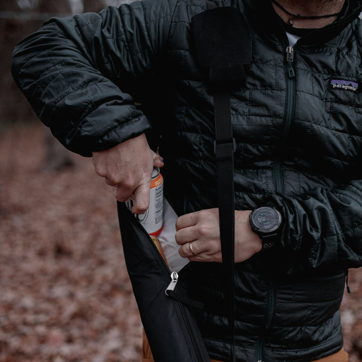 Insulated Beer Sleeve Suds Slinger , man using compact hiking survival tool outdoors on trail