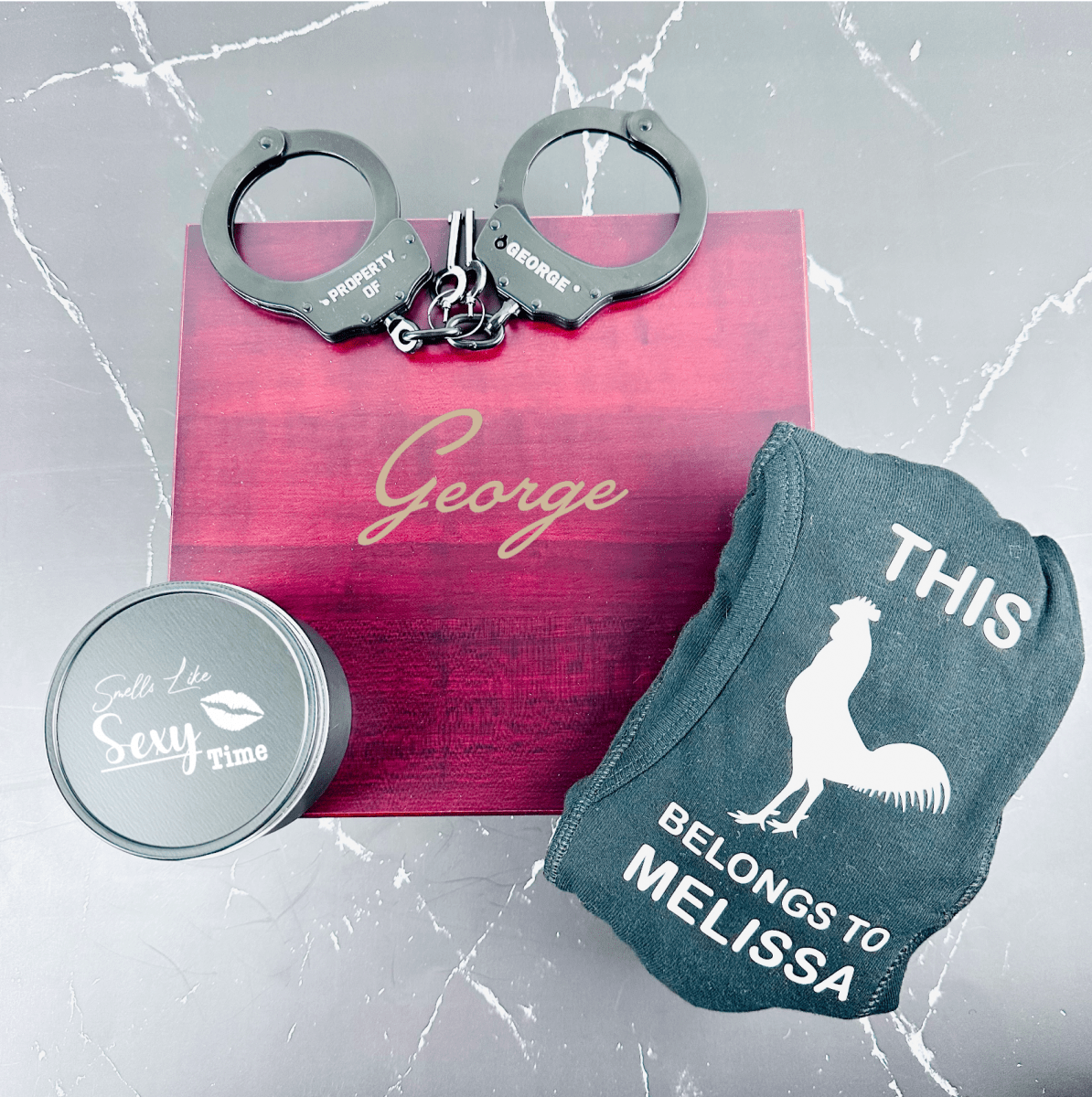 Personalized Sexy Gift Set featuring a custom cedar-lined wooden box, engraved handcuffs, personalized boxers, and a pine-scented candle – perfect for Valentine’s Day, anniversaries, or romantic occasions.
